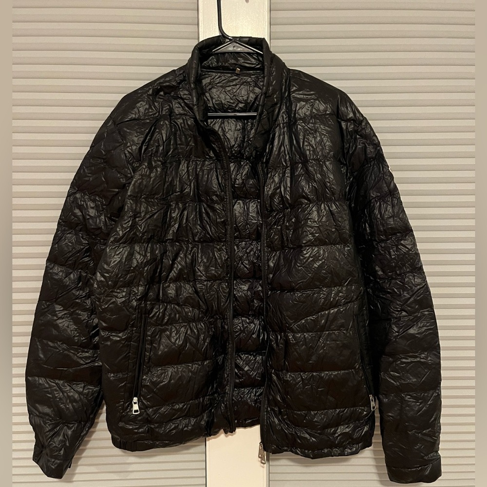 Black Moncler jacket with jacket bag.